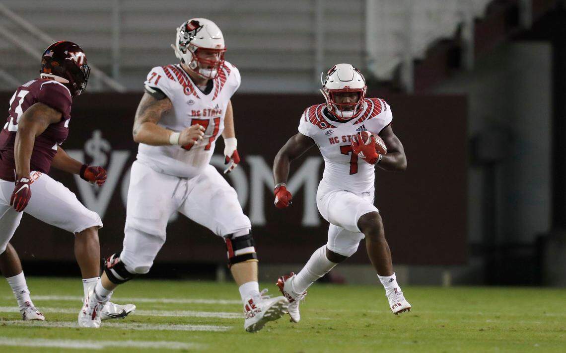 N.C. State running back Zonovan Knight (7) heads downfield with offensive guard Joe Sculthorpe (71) during the first half of N.C. State’s game against Virginia Tech at Lane Stadium in Blacksburg, VA Saturday, Sept. 26, 2020.