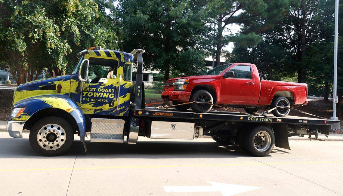 A red pickup truck is transported to the Wake County Detention Center/City-County Bureau of Identification in Raleigh, N.C., Wednesday, August 17, 2022. The truck was seized by law enforcement officials on Wednesday in Winston-Salem in the investigation of the killing of Wake County Deputy Ned Byrd.