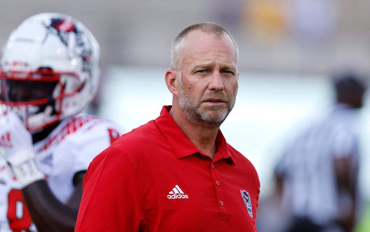 N.C. State head coach Dave Doeren watches the team warm up before N.C. State’s game against ECU at Dowdy-Ficklen Stadium in Greenville, N.C., Saturday, Sept. 3, 2022.