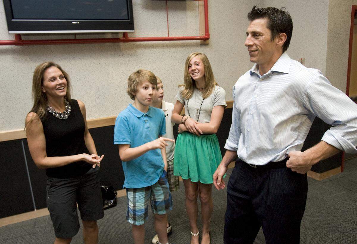 Rod Brind’Amour talks with his fiance, Amy Biedenbach, left, and his children Reece Brind’Amour, left center, 9, Skyler Brind’Amour, center, 10, and and Briley Brind’Amour, right center, 12, after he announced his retirement Wedensday at the RBC Center. CHRIS SEWARD - cseward@newsobserver.com