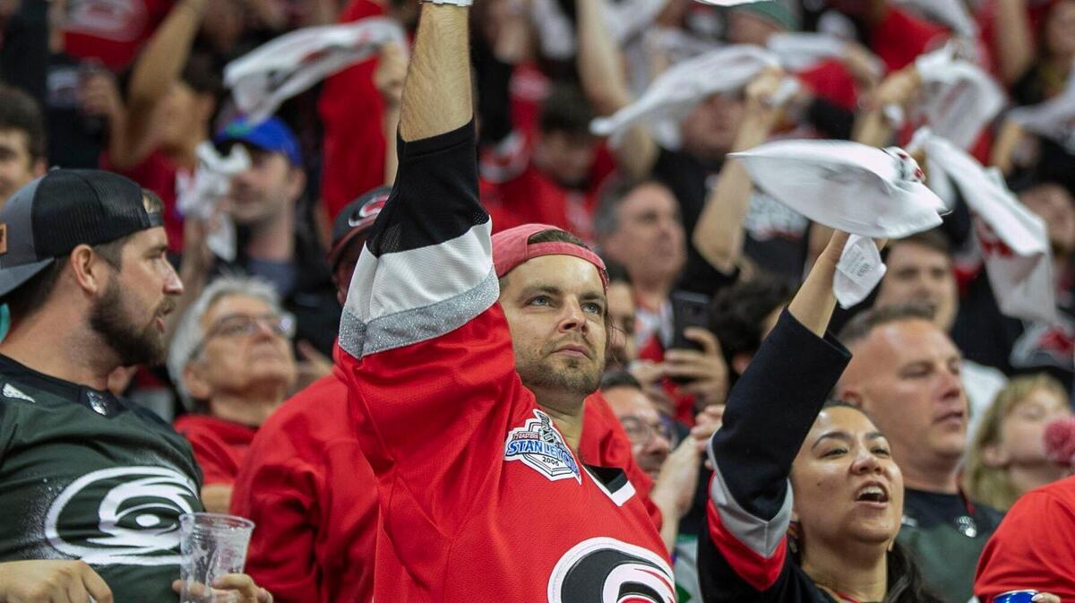 Carolina Hurricanes fans celebrate after a goal by Jesper Fast (71) in the first period against the Boston Bruins on Wednesday, May 4, 2022 during game two of their Stanley Cup first round series at PNC Arena in Raleigh, N.C.