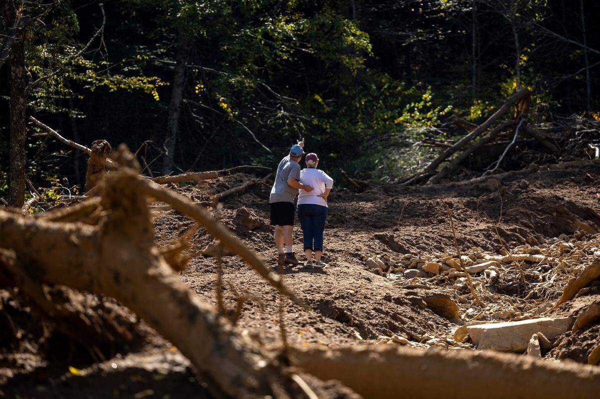 Michael Heatherly, 54, and his mother Linda, 77, survey damage caused by a landslide on their family’s property in Cruso. The remnants of Hurricane Helene caused more than 300 landslides, many in North Carolina.