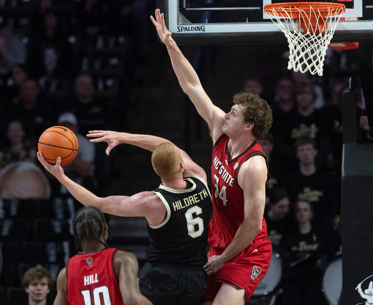 N.C. State’s Ben Middlebrooks contests a shot by Wake Forest’s Cameron Hildreth during the first half of the Wolfpack’s 77-59 loss on Saturday, Jan. 4, 2025, at Lawrence Joel Veterans Memorial Coliseum in Winston-Salem, N.C.