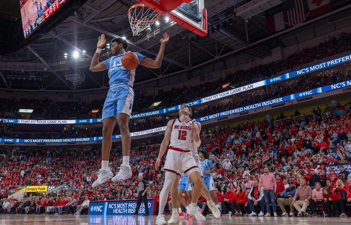 North Carolina forward Jalen Washington (13) scores the game winning basket on a dunk over N.C. State’s Michael O’Connell (12), with 24 seconds to play, securing the Tar Heels’ 63-61 victory on Saturday, January 11, 2025 at Lenovo Center in Raleigh, N.C.