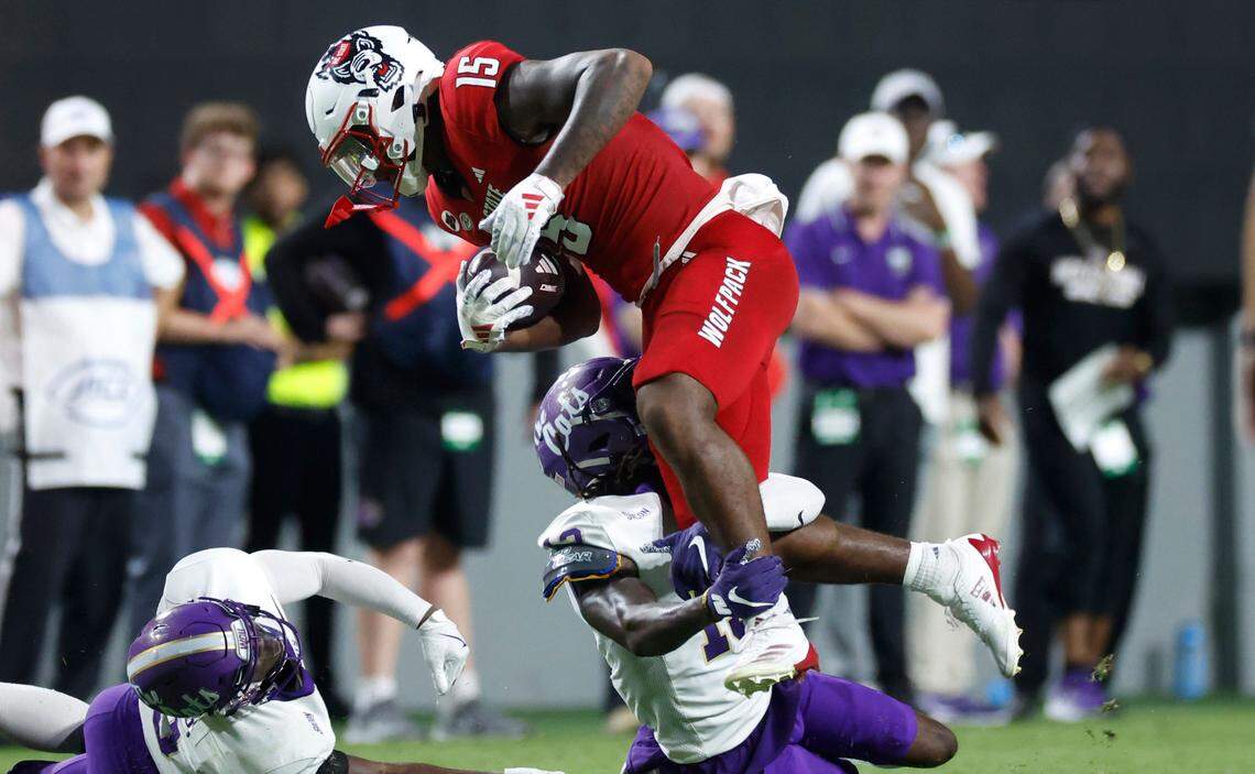 N.C. State tight end Justin Joly (15) tries to get by Western Carolina defensive back Quez Royal (13) during the first half of N.C. State’s game against Western Carolina at Carter-Finley Stadium in Raleigh, N.C., Thursday, August 29, 2024.