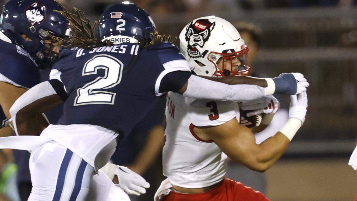 N.C. State running back Jordan Houston (3) tries to get around Connecticut defensive back Durante Jones (2) during the first half of N.C. State’s game against UConn at Rentschler Field in East Hartford, Conn. Thursday, August 31, 2023.