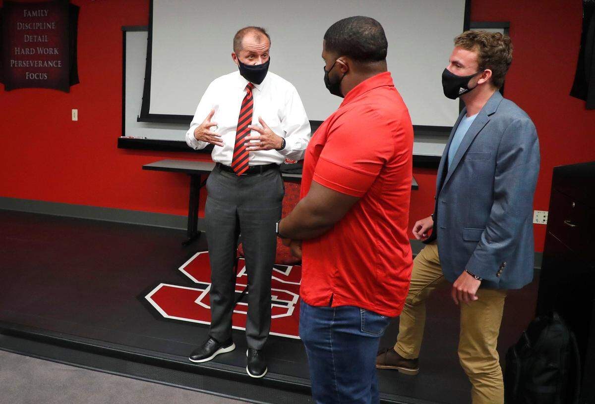 ACC Commissioner Jim Phillips talks with N.C. State’s Grant Gibson and Peyton Barish after speaking with the leadership of Pack United at the Murphy Center in Raleigh, N.C. Monday, May 3, 2021.