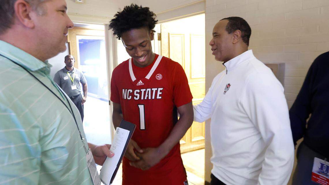 N.C. State head coach Kevin Keatts congratulates Jarkel Joiner after Joiner was informed Tuesday, Feb. 28, 2023, that he is the winner of the Caulton Tudor Award which recognizes the Triangle basketball player who is most cooperative with the local media in honor of the late News & Observer sports columnist.