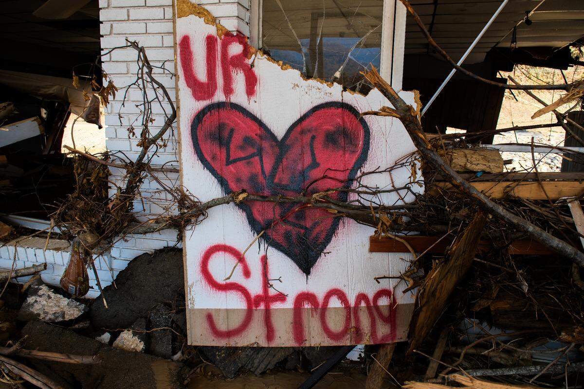A sign of encouragement rests amid the debris of a gas station destroyed by Hurricane Helene in Swannanoa, N.C., on Oct. 26, 2024.