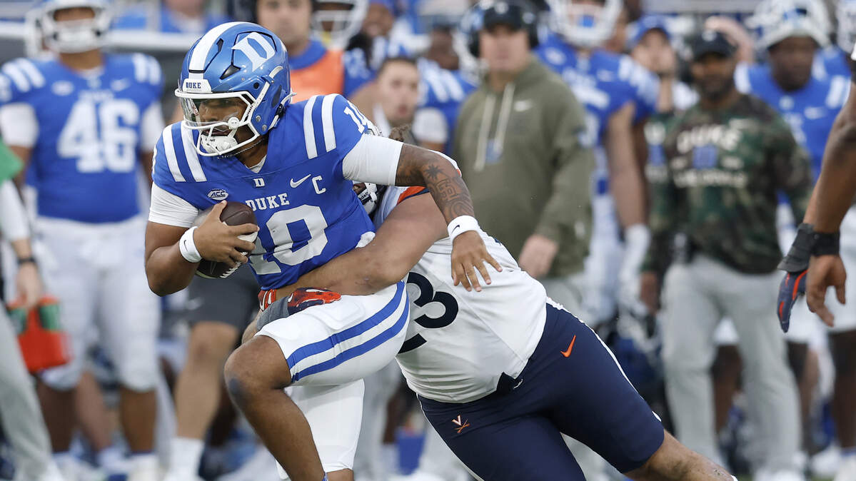 Duke quarterback Darian Mensah is sacked by Virginia’s Jacob Holmes during the first half of the Blue Devils’ game on Saturday, Nov. 15, 2025, at Wallace Wade Stadium in Durham, N.C.