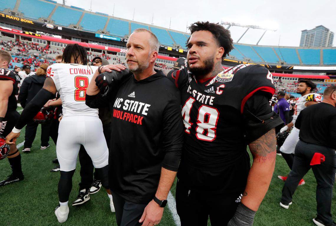 “I love you coach” says defensive tackle Cory Durden (48) to N.C. State head coach Dave Doeren. “I love you” Doeren responds as they walk off after Maryland’s 16-12 victory over N.C. State in the Duke’s Mayo Bowl at Bank of America Stadium in Charlotte, N.C., Friday, Dec. 30, 2022.