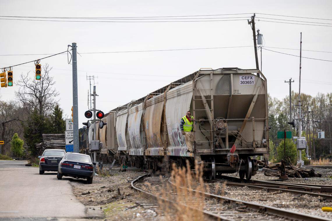 A train travels along the tracks near the Driver Street crossing in Durham on March 22, 2024. A man was killed at the crossing earlier this month when his car became trapped between the crossing arms.