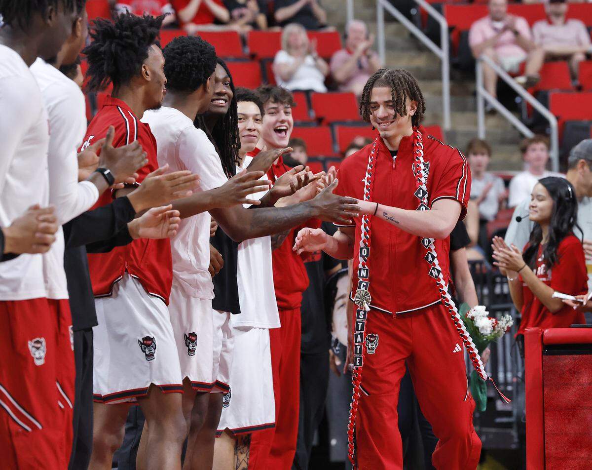 N.C. State’s Jordan Snell is greeted by teammates during a Senior Day ceremony prior to the Wolfpack’s game against Stanford on Saturday, March 7, 2026, at Lenovo Center in Raleigh, N.C.