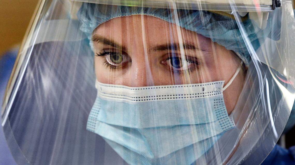 Katie Sessoms, RN, cares for COVID patients in the Medical Intensive Care Unit at UNC Hospital in Chapel Hill, N.C., on Friday, Aug. 27, 2021.