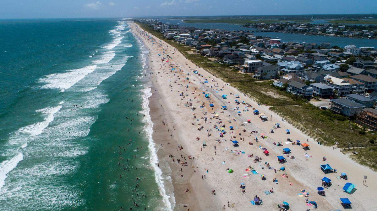 Beachgoers pack Wrightsville Beach Sunday, Aug. 2, 2020 as Tropical Storm Isaias moves along the Southeast Coast.