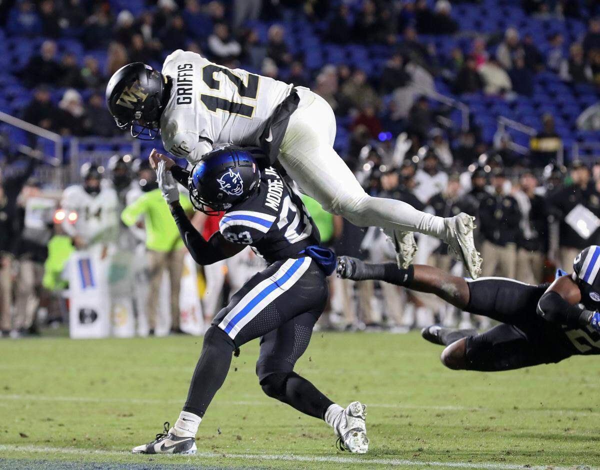 Wake Forest’s Mitch Griffis hurdles over Duke’s Terry Moore to score a touchdown during the second half of the Blue Devils’ 24-21 win on Thursday, Nov. 2, 2023, at Wallace Wade Stadium in Durham, N.C.