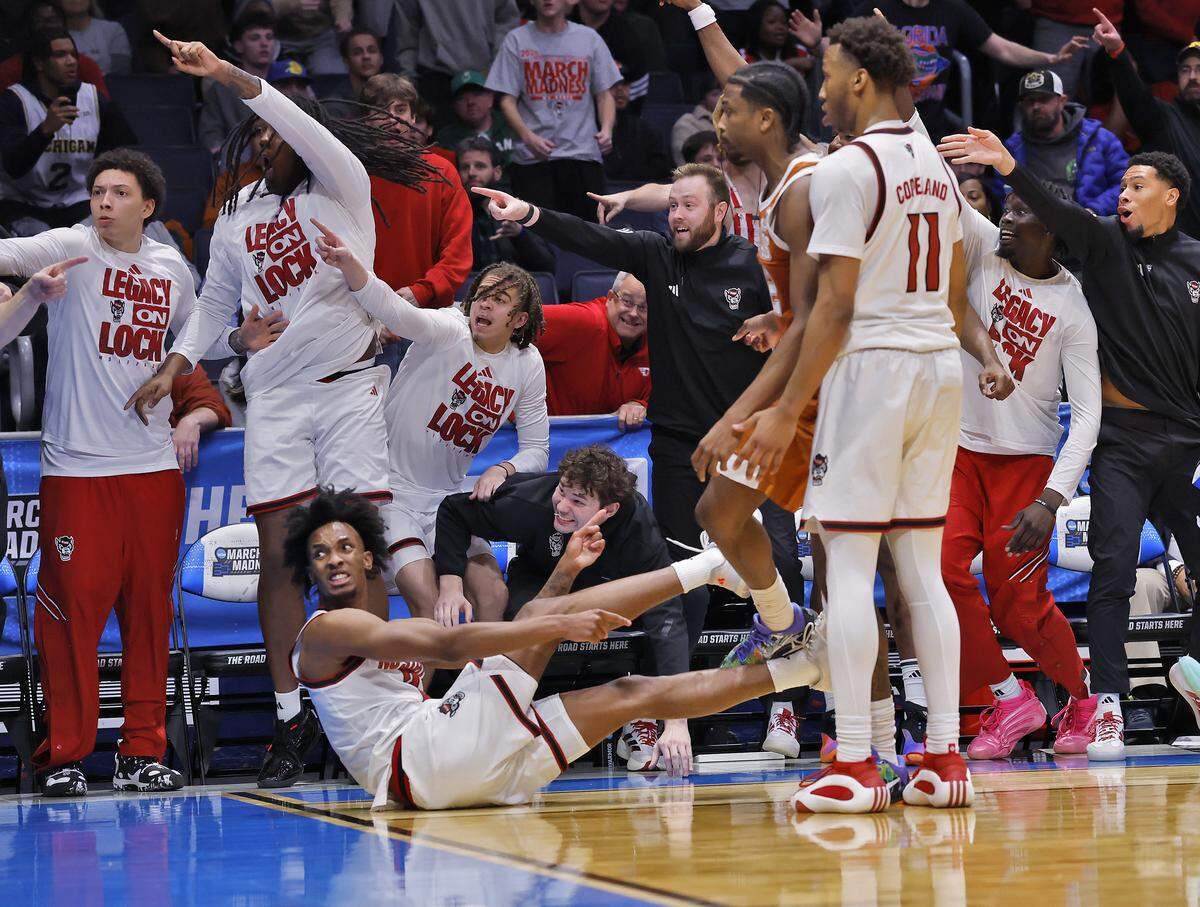 The N.C. State bench protests a call after an official ruled Texas called a timeout prior to Paul McNeil Jr.’s defensive stop late in the second half of the Wolfpack’s 68-66 loss in the NCAA First Four on Tuesday, March 17, 2026,  in Dayton, Ohio. 
