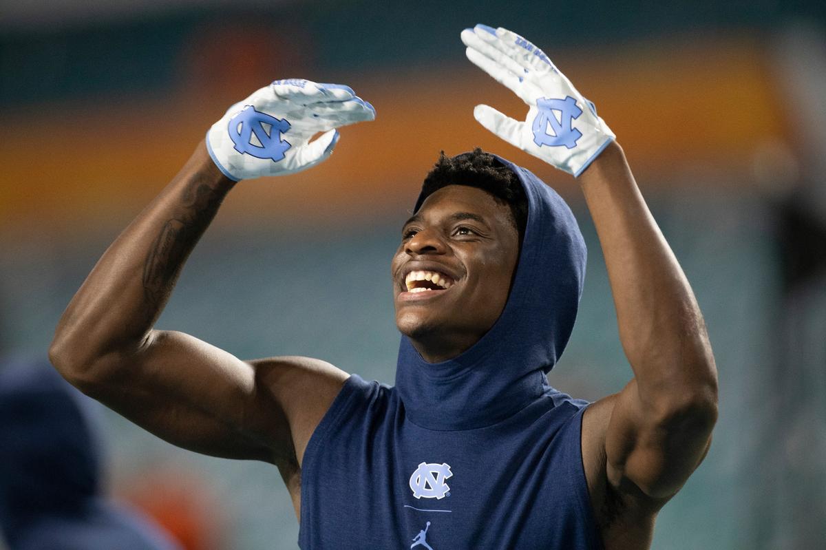 North Carolina defensive back Tony Grimes (20) enjoys the stadium music as he warms for the Tar HeelsÕ game against Texas A&M on Saturday, January 2, 2021 at the Orange Bowl in Miami Gardens, Florida.