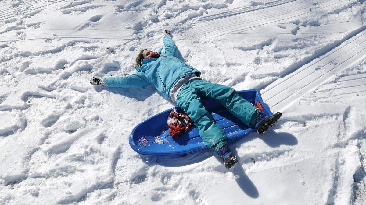 Paige Rowe takes a breather after sledding down one of the hills at Dix Park in Raleigh on Sunday, Feb. 1, 2026.