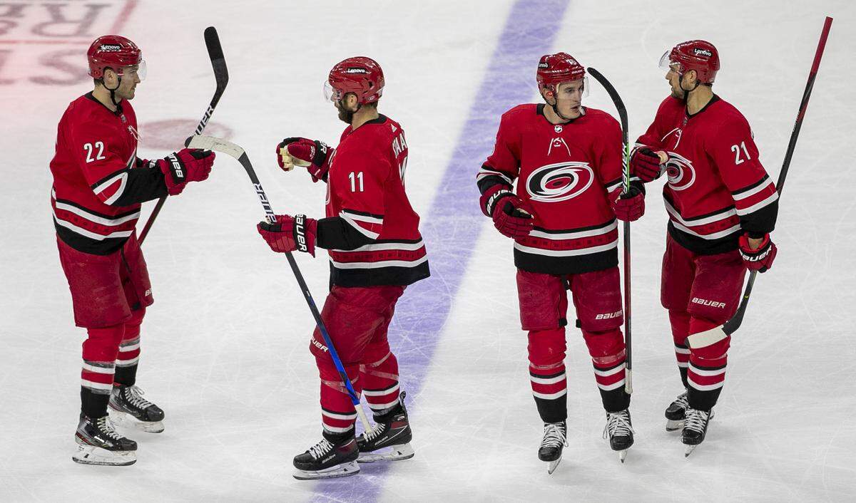 Carolina’s Hurricanes’ Jordan Staal (11) reacts with teammates Brett Pesce (22), Brady Skjei (76) and Nino Niederreiter (21) after scorIng a open net goal to secure a 4-2 victory over Winnipeg in the third period on Thursday, April 21, 2022 at PNC Arena in Raleigh, N.C.