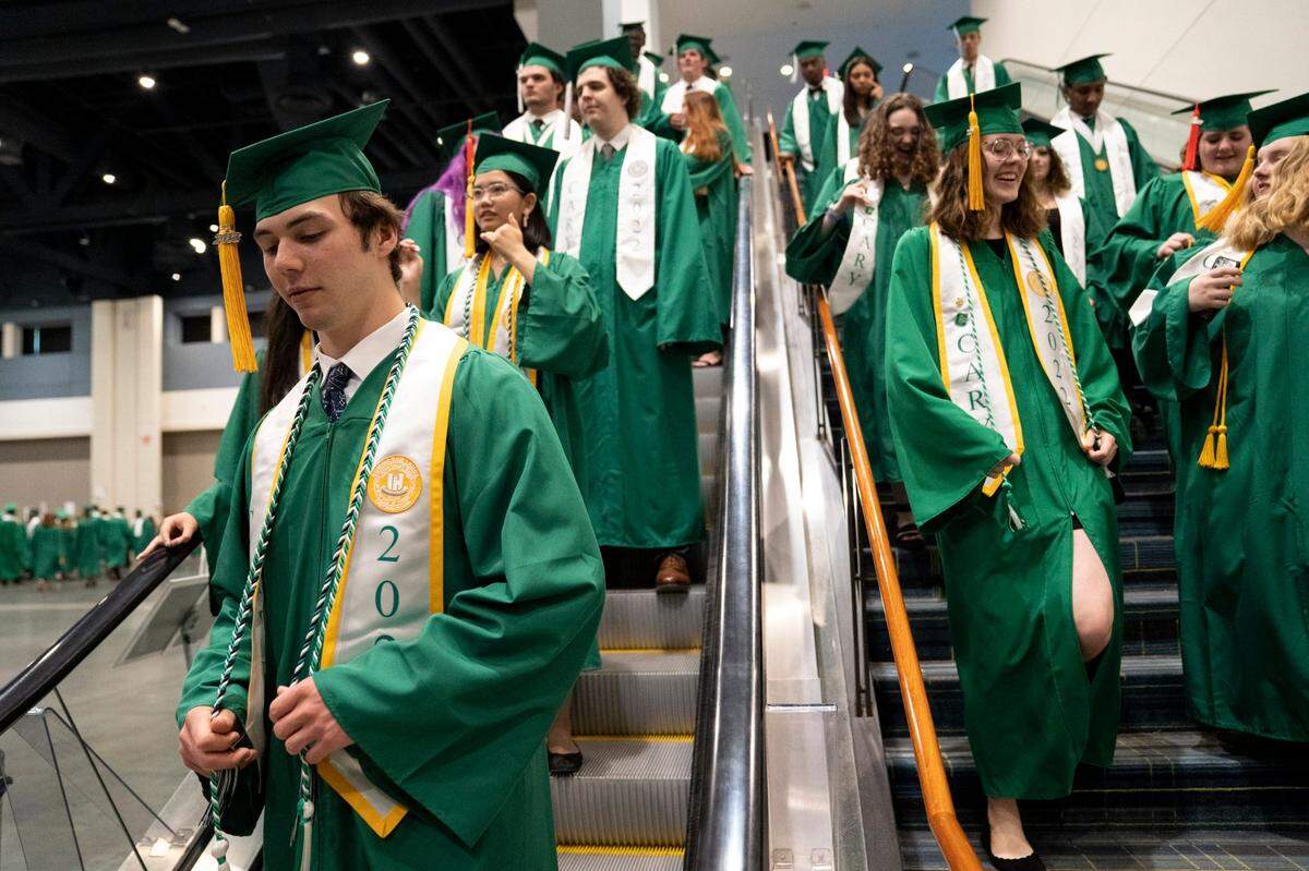 Cary High School Class of 2022 graduates enter the Raleigh Convention Center for the school’s Graduation Ceremony on Wednesday, June 15, 2022.