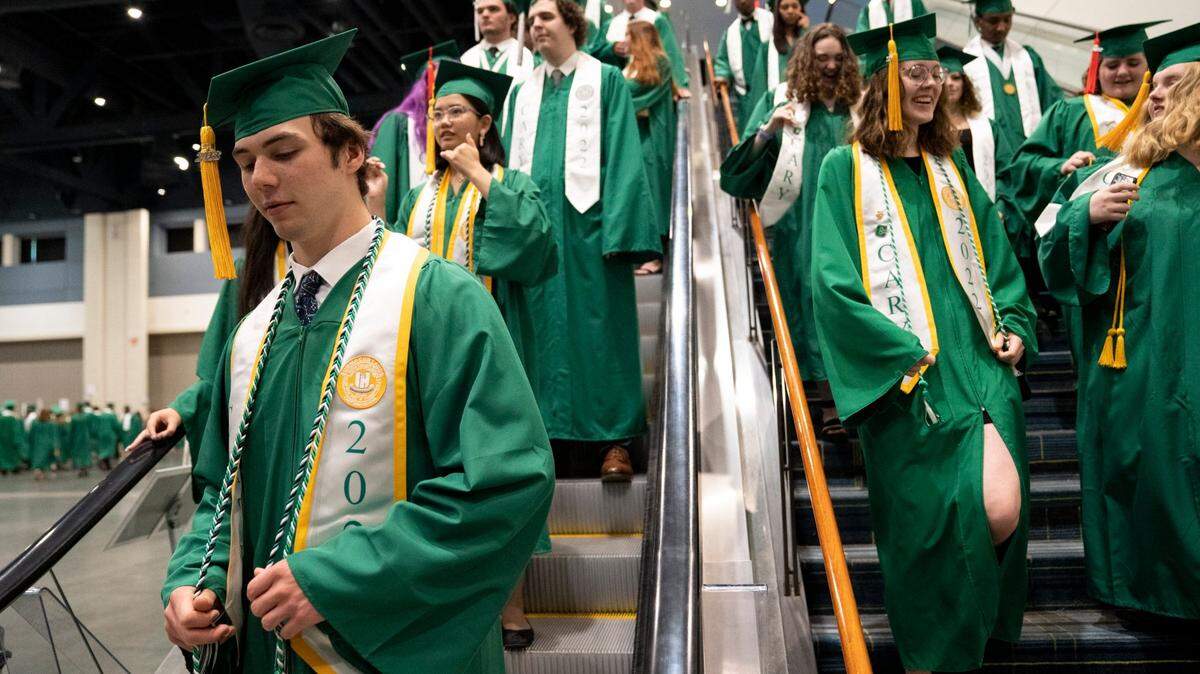 Cary High School Class of 2022 graduates enter the Raleigh Convention Center for the school’s Graduation Ceremony on Wednesday, June 15, 2022.