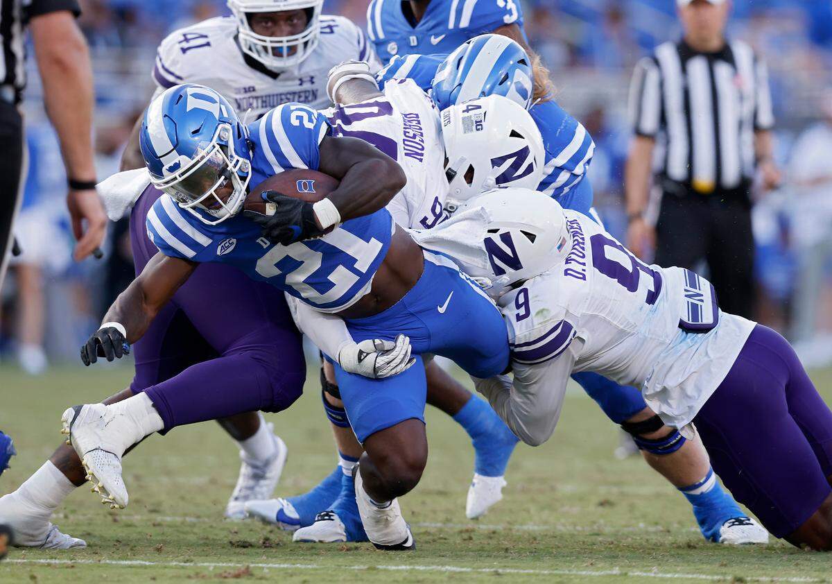 Duke’s Peyton Jones is brought down by Northwestern’s R.J. Pearson and Devin Turner during the second half of the Blue Devils’ 38-14 win on Saturday, Sept. 16, 2023, at Wallace Wade Stadium in Durham, N.C.