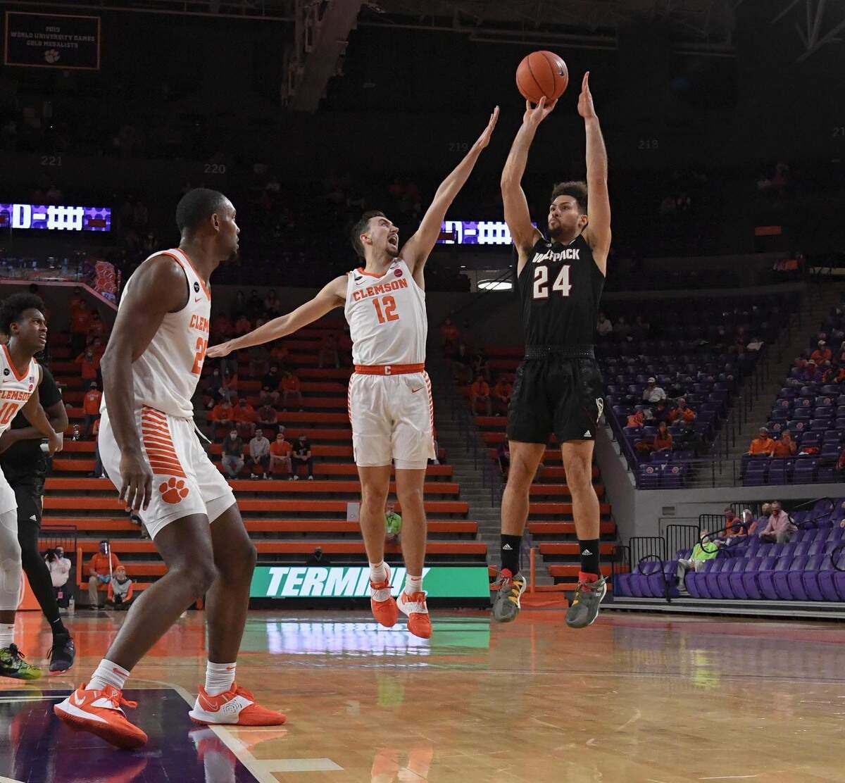 NC State guard Devon Daniels(24) shoots as Clemson sophomore guard Alex Hemenway(12) defends during the first half of their game on Jan. 5, 2021.