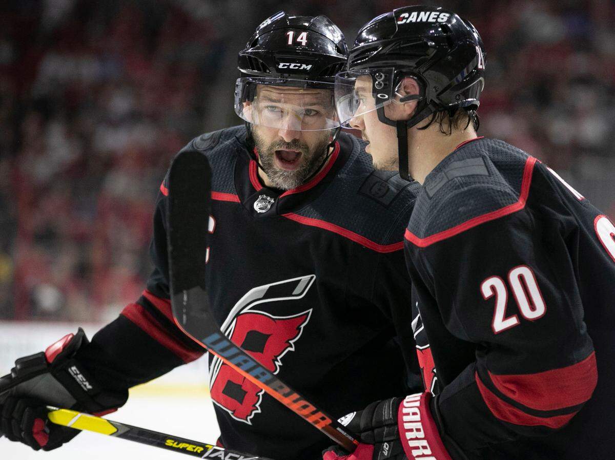 Carolina Hurricanes’ Justin Williams (14) confers with Sebastian Aho (20) during the first period in Game 4 of their Stanley Cup series on Friday, May 3, 2019 at PNC Arena in Raleigh, N.C.