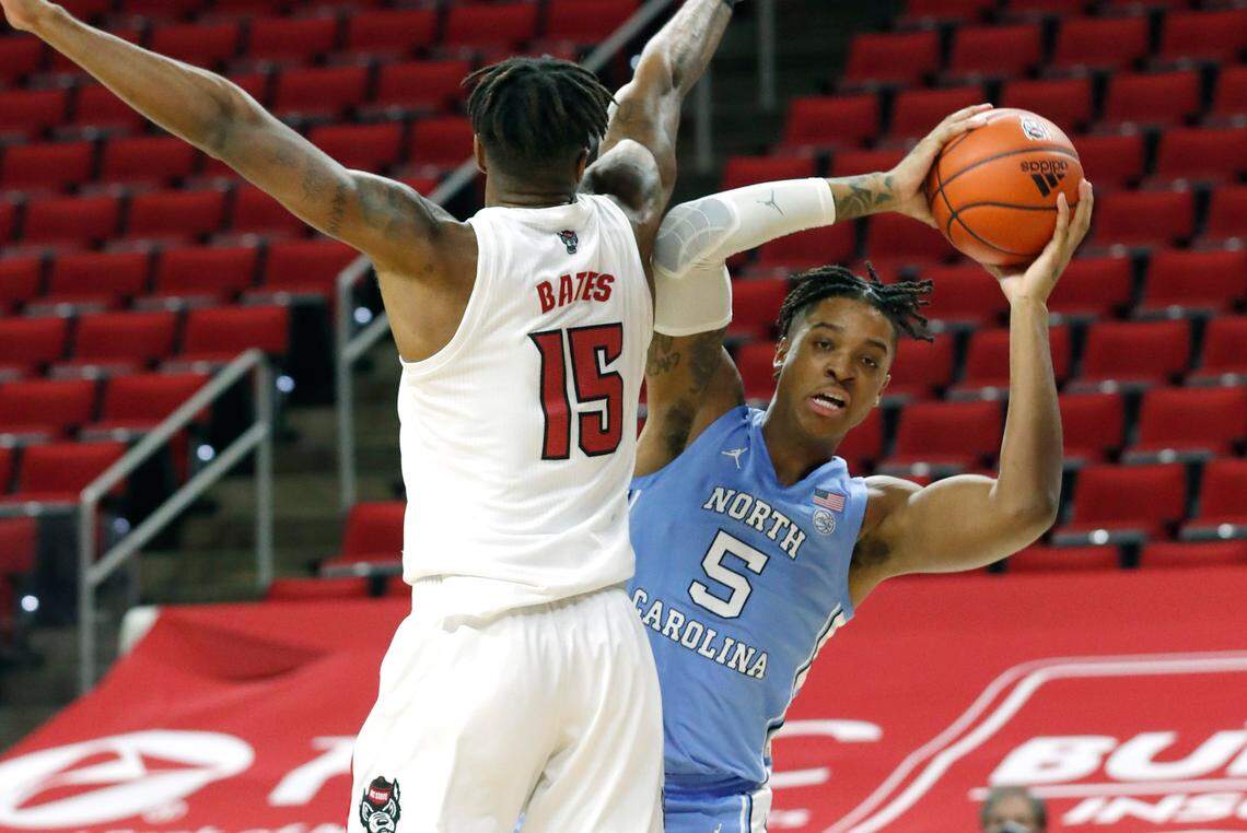 North Carolina’s Armando Bacot (5) looks for room as N.C. State’s Manny Bates (15) defends during the first half of N.C. State’s game against UNC at PNC Arena in Raleigh, N.C., Tuesday, December 22, 2020.