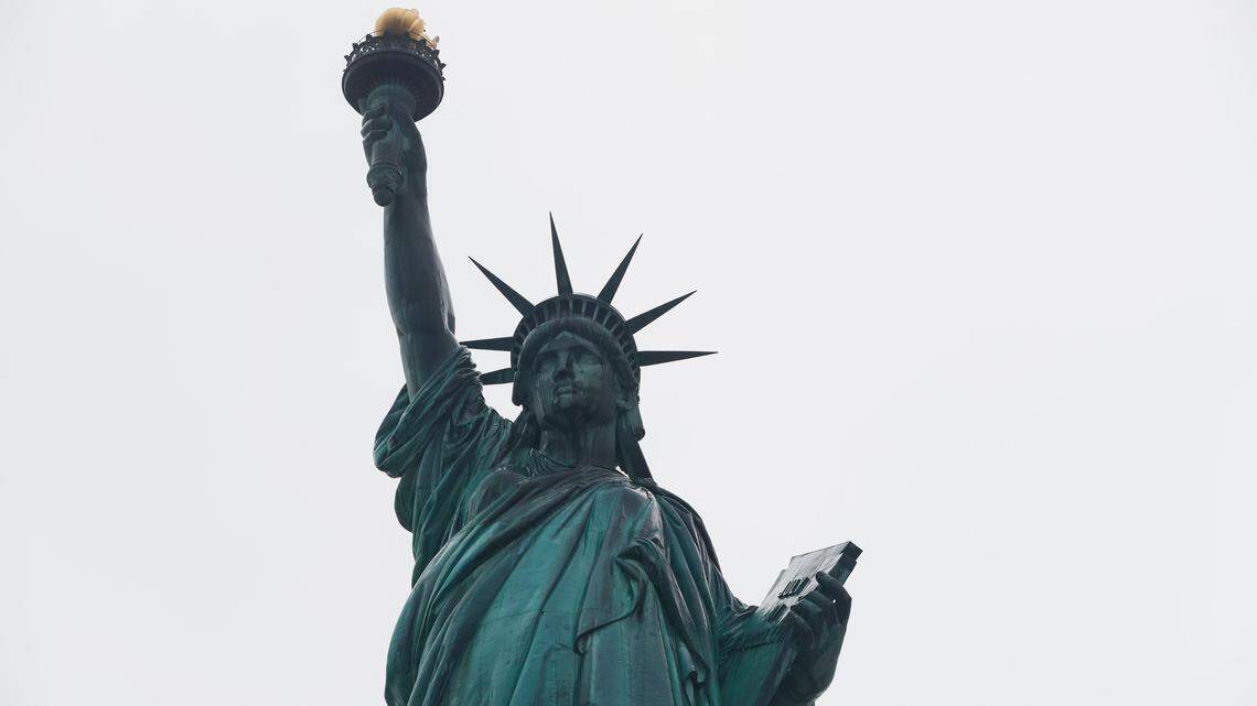 The Statue of Liberty wields her torch, Wednesday, Aug. 14, 2019, on a cloudy day in New York. A biographer of poet Emma Lazarus on Wednesday challenged a comment by the acting director of U.S. Citizenship and Immigration Services, explaining that Lazarus’ words were her way of urging Americans “to embrace the poor and destitute of all places and origins.” (AP Photo/Kathy Willens)