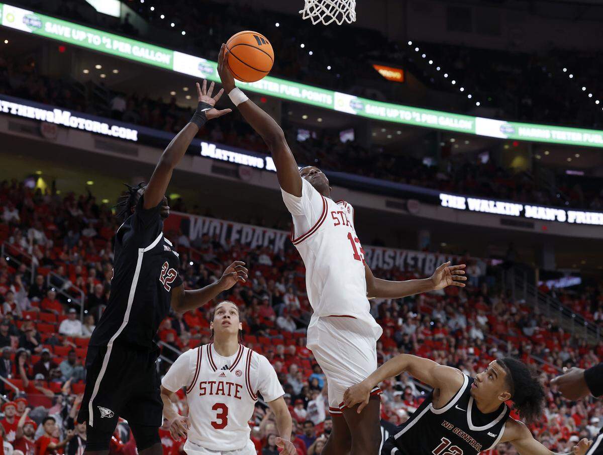 N.C. State’s Musa Sagnia grabs a rebound away from North Carolina Central’s Ramondo Battle II (22) during the second half of the Wolfpack’s 114-66 win at Lenovo Center on Monday, Nov. 3, 2025, in Raleigh, N.C.