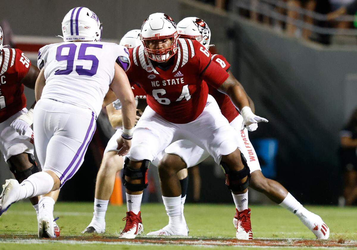 N.C. State’s Chandler Zavala (64) prepares to block Furman’s Parker Stokes (95) during the Wolfpack’s game against Furman at Carter-Finley Stadium in Raleigh, N.C., Saturday, Sept 18, 2021.