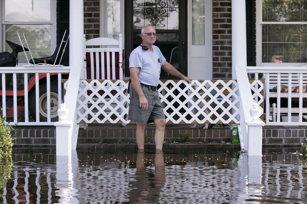 Brittons Neck volunteer Fire Chief Wyman Watson stands on his flooded front porch on Bay Rd. in Brittons Neck. Residents of Brittons Neck in Marion County are nearing the crest the flooding from the Little Pee Dee River on Saturday, but many are concerned that the flooding Great Pee Dee will increase damage to their community. Sept. 22, 2018.