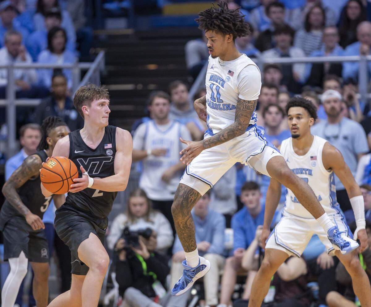 North Carolina guard Jonathan Powell (11) defends Virginia Tech guard Jaden Schutt (2) in the first half on Saturday, February 28, 2026 at the Smith Center in Chapel Hill, N.C.