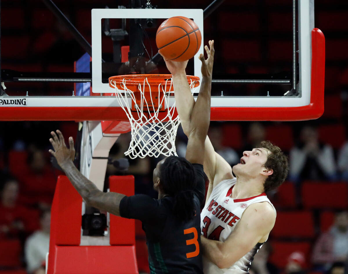 N.C. State’s Ben Middlebrooks blocks a shot by Miami’s. Christian Watson during the first half of the Wolfpack’s 74-68 win on Tuesday, Jan. 30, 2024, at PNC Arena in Raleigh, N.C.