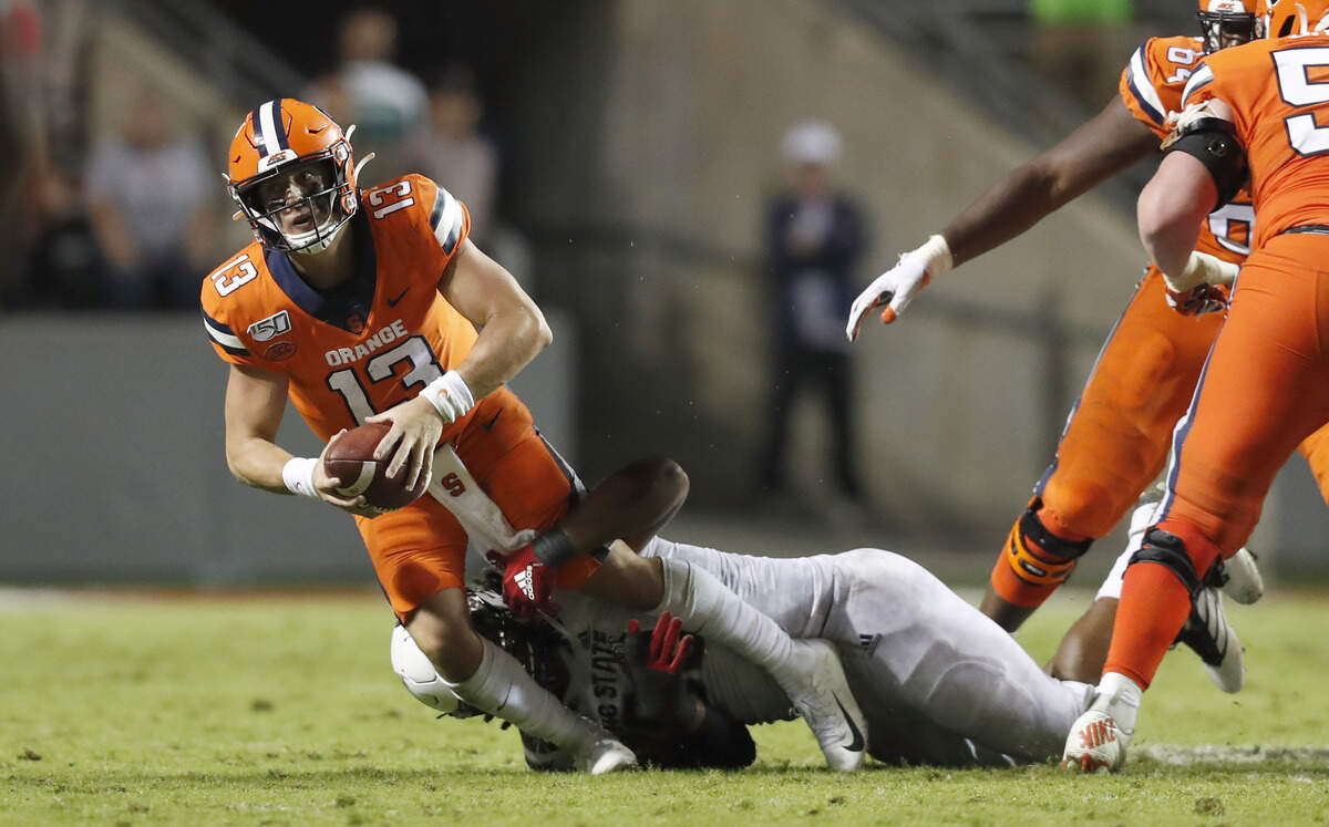 N.C. State defensive tackle Larrell Murchison (92) sacks Syracuse quarterback Tommy DeVito (13) at the end of the second half of N.C. State’s 16-10 victory over Syracuse at Carter-Finley Stadium in Raleigh, N.C., Thursday, Oct. 10, 2019.