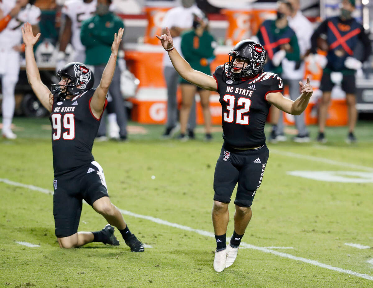 N.C. State place kicker Christopher Dunn (32) and Trenton Gill (99) celebrate Dunn’s 53-yard field goal during the second half of Miami’s 44-41 victory over N.C. State at Carter-Finley Stadium in Raleigh, N.C., Friday, Nov. 6, 2020.