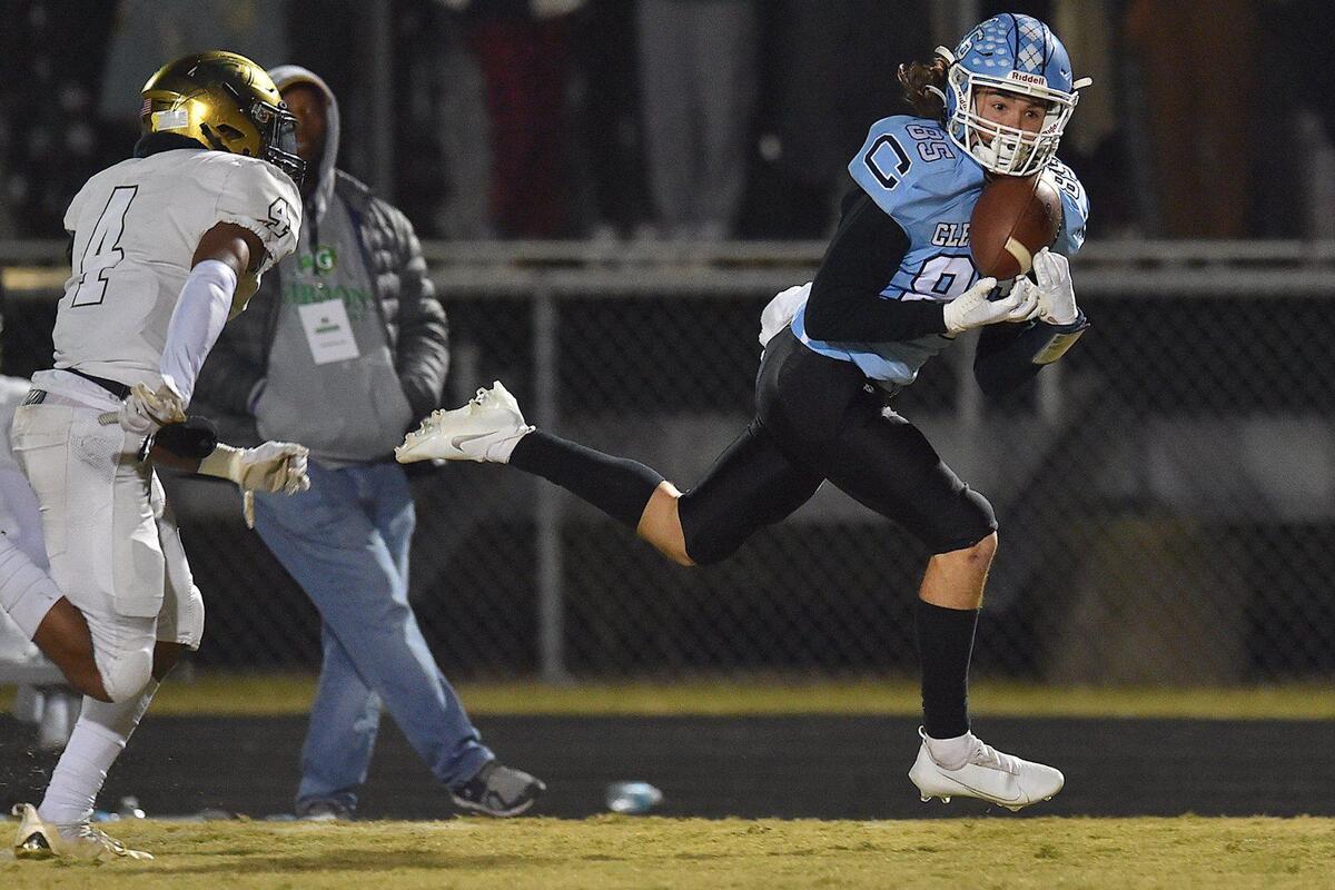 Cleveland’s Cameron Inscoe (85) makes the catch ahead of Cardinal Gibbons’ Tristen Beasley (4) during the second quarter. The Cardinal Gibbons Crusaders and the Cleveland Rams met in the third round of the NCHSAA 4A football playoffs on November 19, 2021