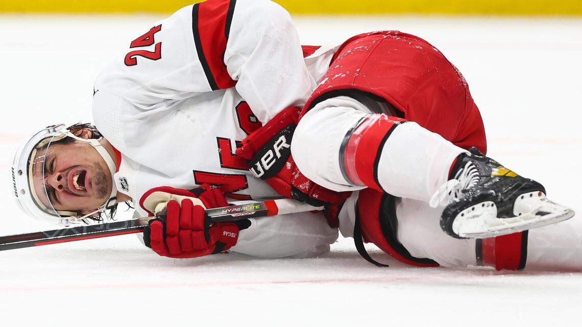 Seth Jarvis (24) of the Carolina Hurricanes reacts after being hit by a loose puck in the second period against the Boston Bruins in Game Four of the First Round of the 2022 Stanley Cup Playoffs at TD Garden on Sunday, May 8, 2022 in Boston. (Adam Glanzman/Getty Images/TNS)