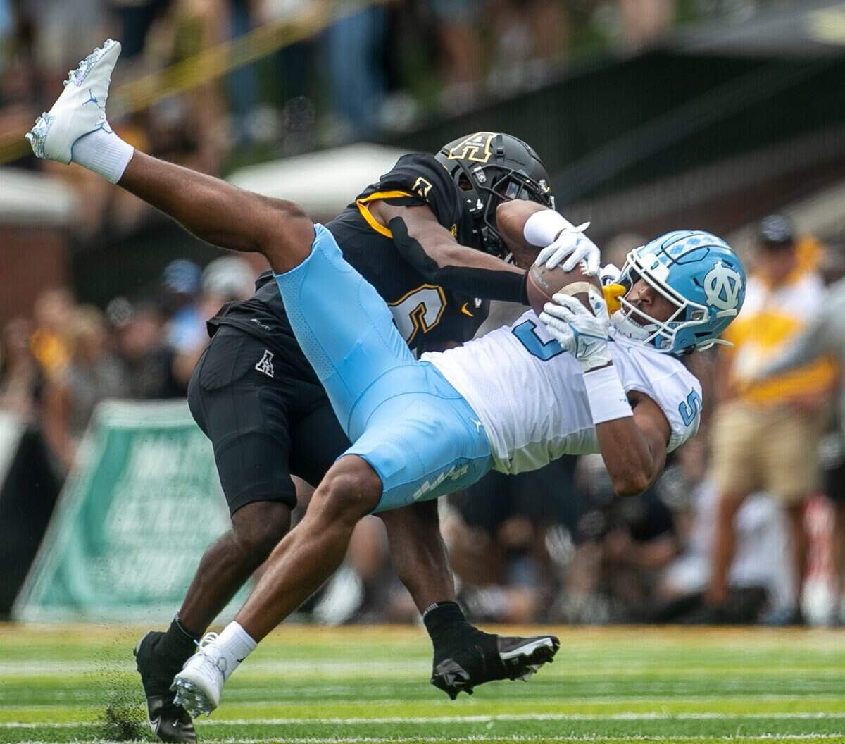 North Carolinas J.J. Jones (5) pulls in a pass from quarterback Drake Maye (10) for a 31-yard gain in the first quarter against Appalachian States Steven Jones Jr. (6) on Saturday, September 3, 2022 at Kidd Brewer Stadium in Boone, N.C.