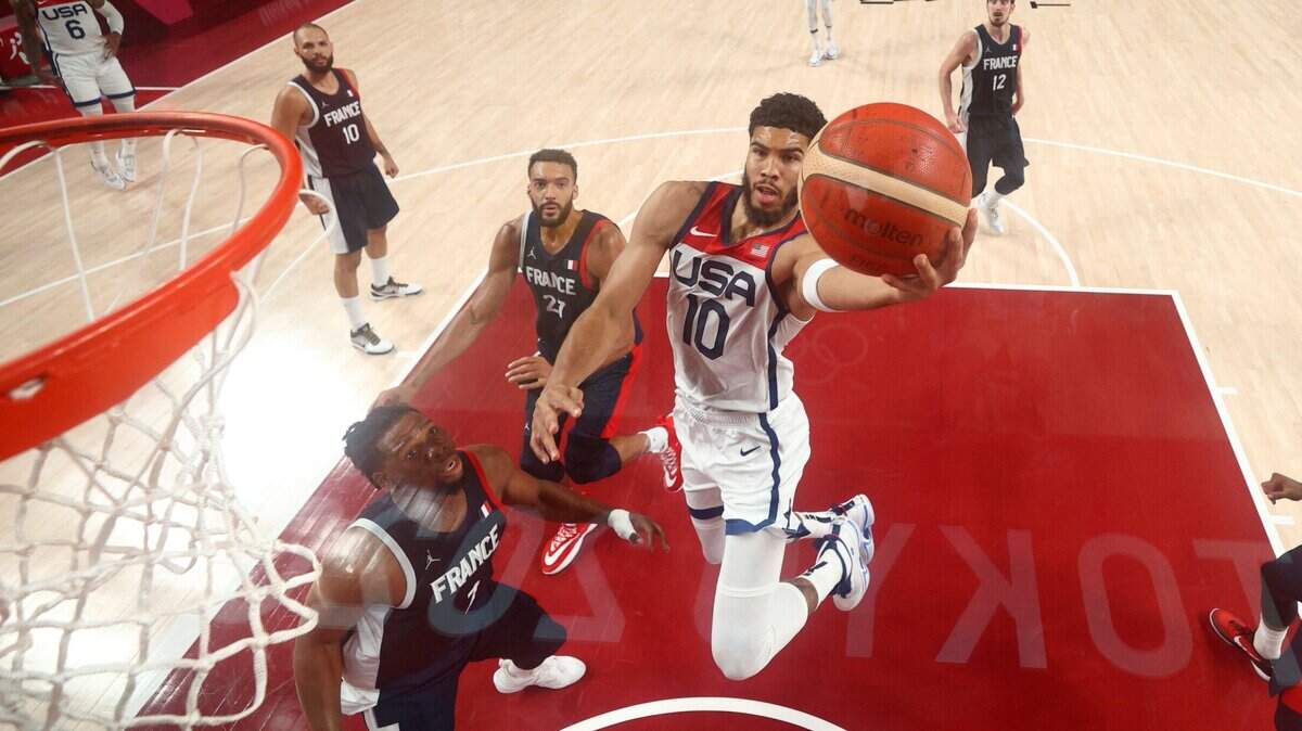 United States’ Jayson Tatum (10) drives to the basket over France’s Guerschon Yabusele, left, during the men’s basketball gold medal game at the 2020 Summer Olympics, Saturday, Aug. 7, 2021, in Saitama, Japan. (Gregory Shamus/Pool Photo via AP)
