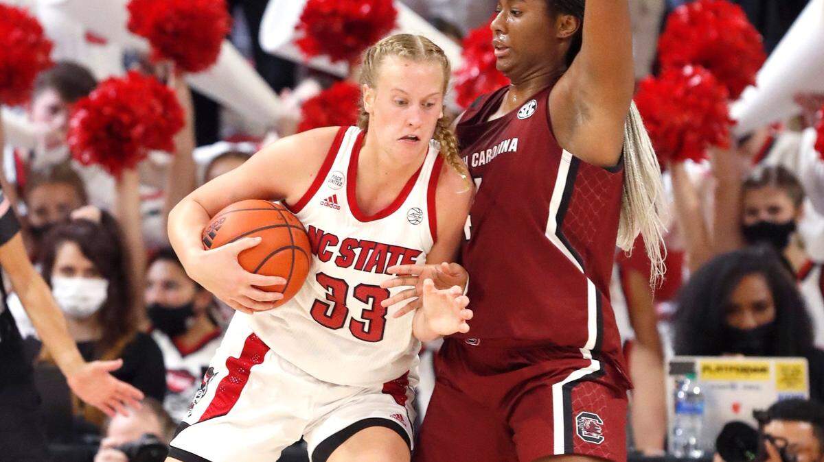 N.C. State’s Elissa Cunane (33) looks for room as South Carolina’s Aliyah Boston (4) defends during the first half of N.C. States game against South Carolina at Reynolds Coliseum in Raleigh, N.C., Tuesday, November 9, 2021.