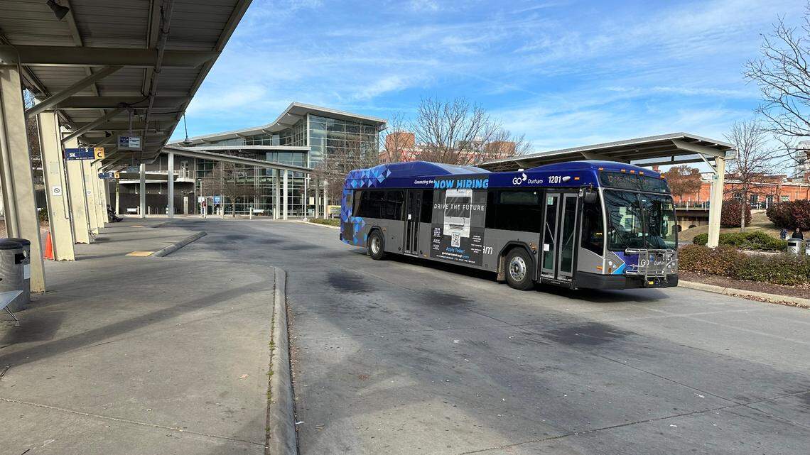 A GoDurham bus pulls out of Durham Station on Dec. 8, 2023. The agency has begun placing QR codes at bus stops that riders and others can use to report problems.