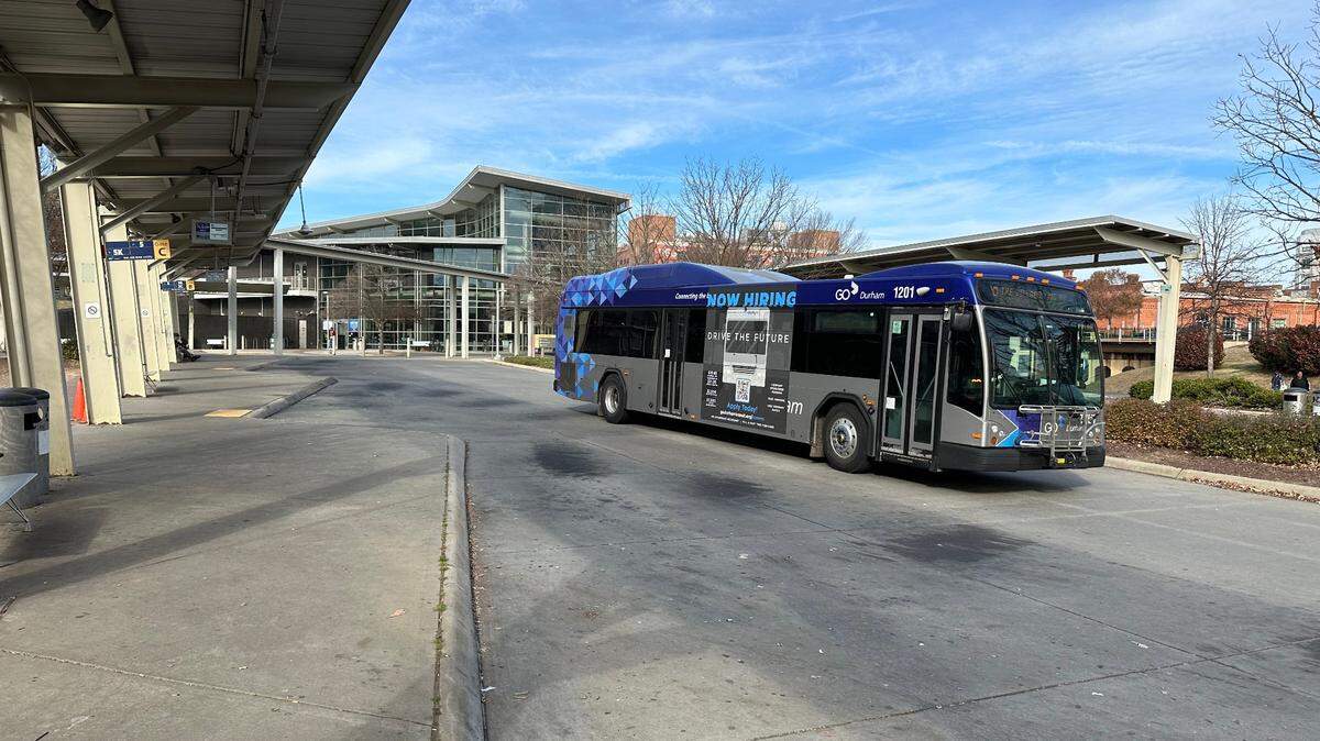 A GoDurham bus pulls out of Durham Station on Dec. 8, 2023. The agency has begun placing QR codes at bus stops that riders and others can use to report problems.
