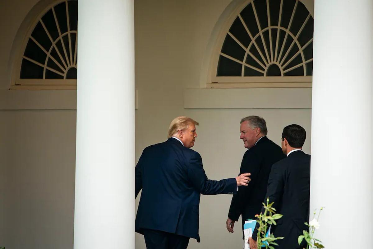 President Donald Trump walks on the West Wing colonnade with White House Chief of Staff Mark Meadows, and John McEntee, White House director of presidential personnel, at the White House, on Friday, Sept. 11, 2020.