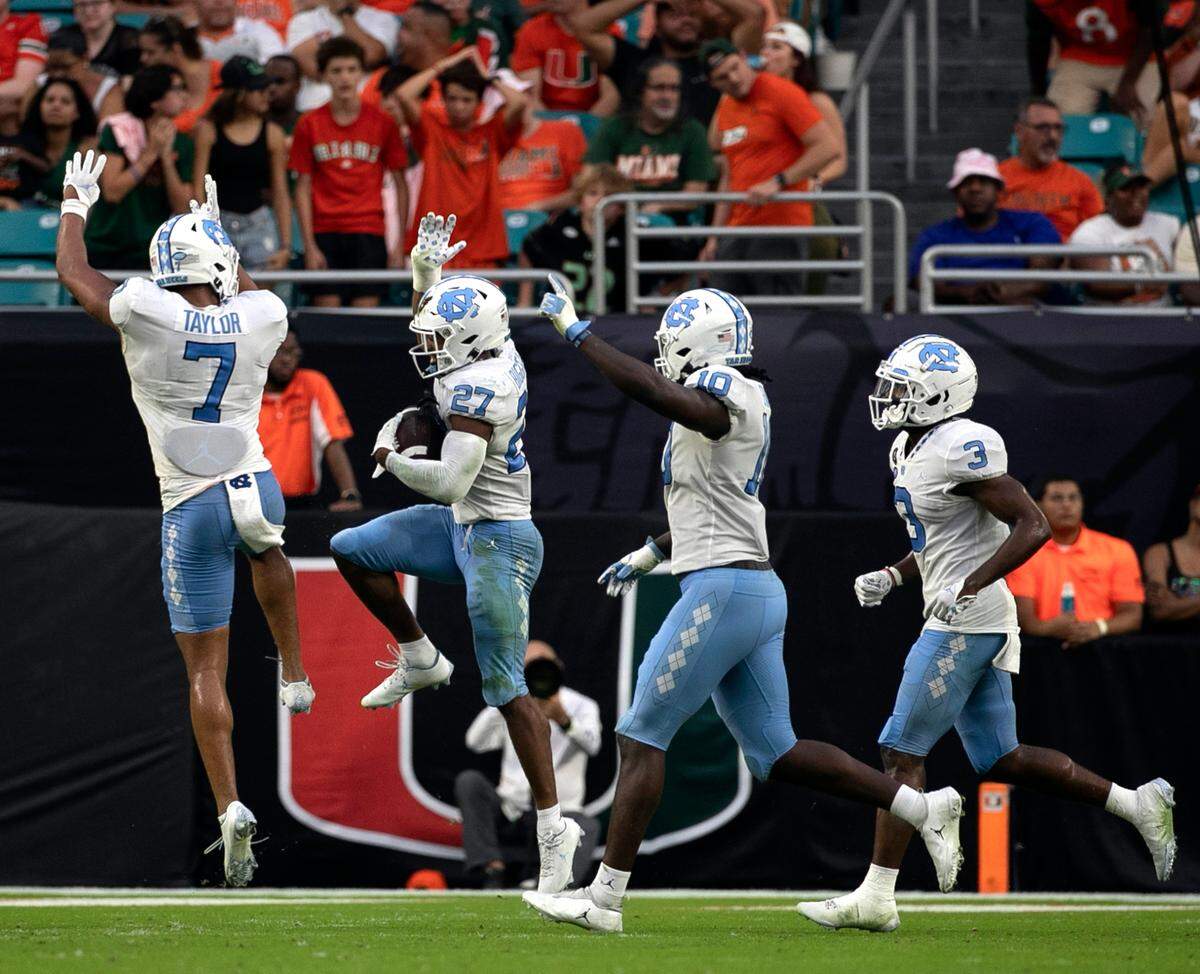 North Carolina’s Giovanni Biggers (27) celebrates with teammates after recovering a fumble by Miami’s Jaylan Knighton in the fourth quarter on Saturday, October 8, 2022 at Hard Rock Stadium in Miami Gardens, Florida.