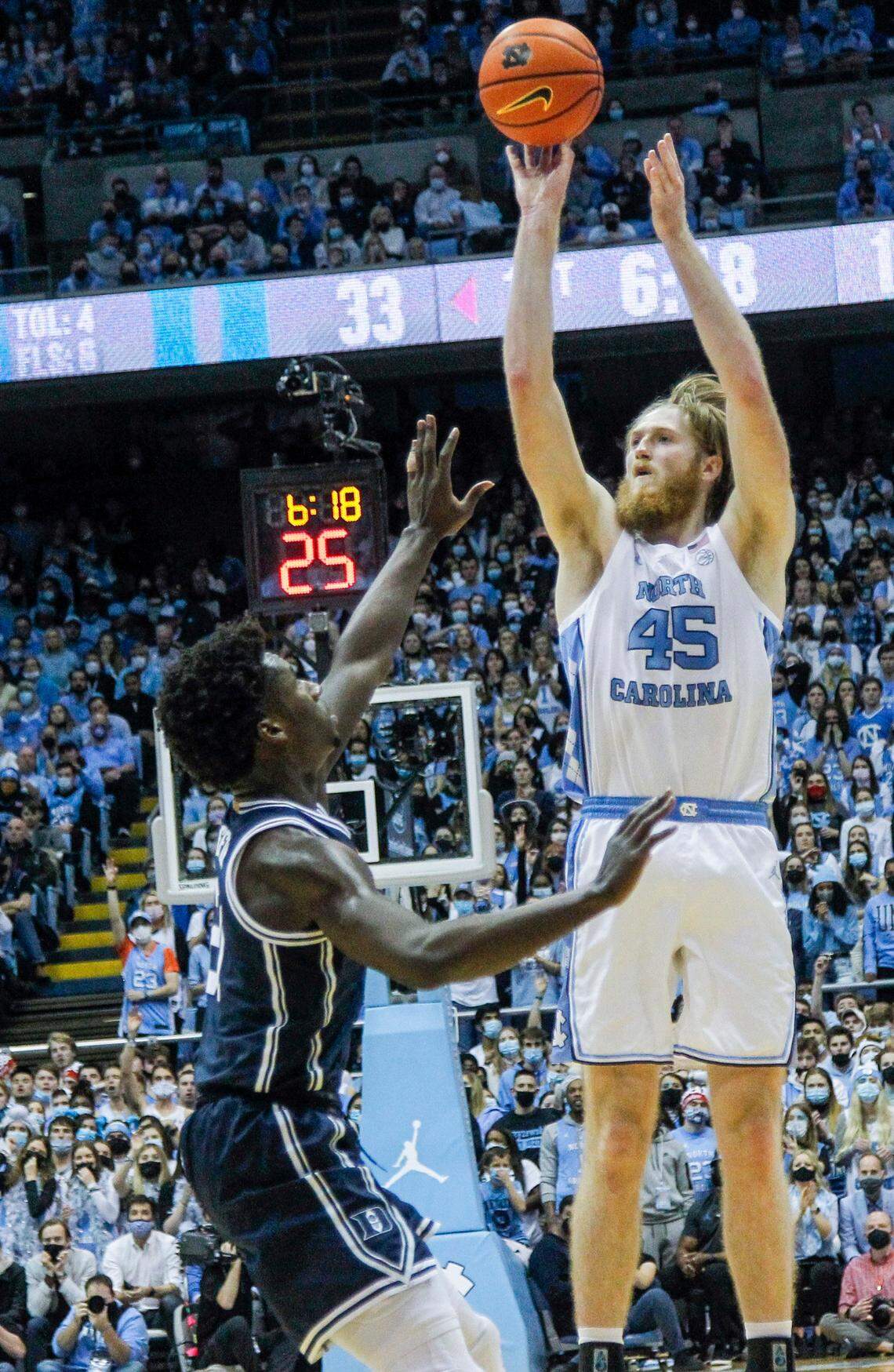 North Carolina’s Brady Manek (45) shoots for three points over Duke’s AJ Griffin (21) during the first half of UNC’s game against Duke Saturday, Feb. 5, 2022 at the Dean Smith Center. Duke won 87-67.