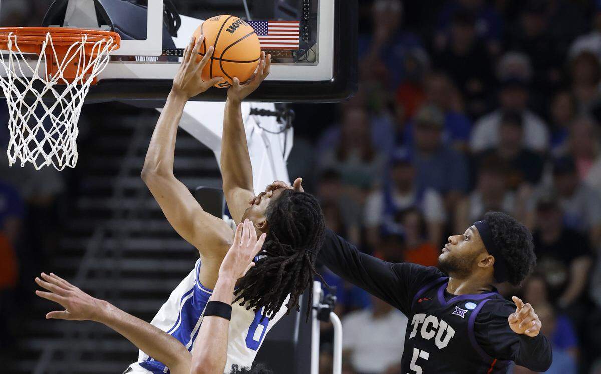 TCUÕs Micah Robinson (5) tries to stop DukeÕs Maliq Brown (6) during the first half of DukeÕs game against TCU in the second round of the NCAA MenÕs Basketball Tournament at  Bon Secours Wellness Arena in Greenville, S.C., Saturday, March 21, 2026. No foul was called.
