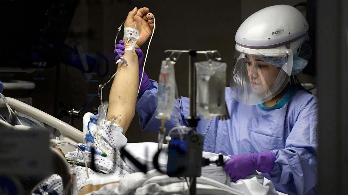 Registered nurse Kat Phillips cares for a Covid patient in the Medical Intensive Care Unit (MICU) at UNC Hospital in Chapel Hill on Thanksgiving Day, Thursday, Nov. 26, 2020.